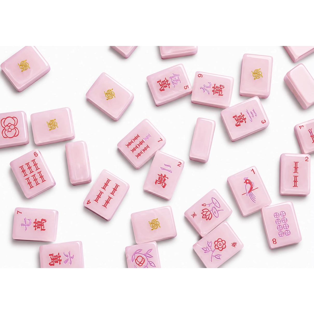 Petal Pink Tradewind mahjong tiles scattered — craks, flowers, winds, and gold jokers