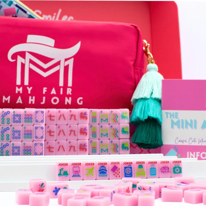 Pink Go Anywhere mini mahjong set: pink carry-all bag with tassel, travel jokers on rack and info card