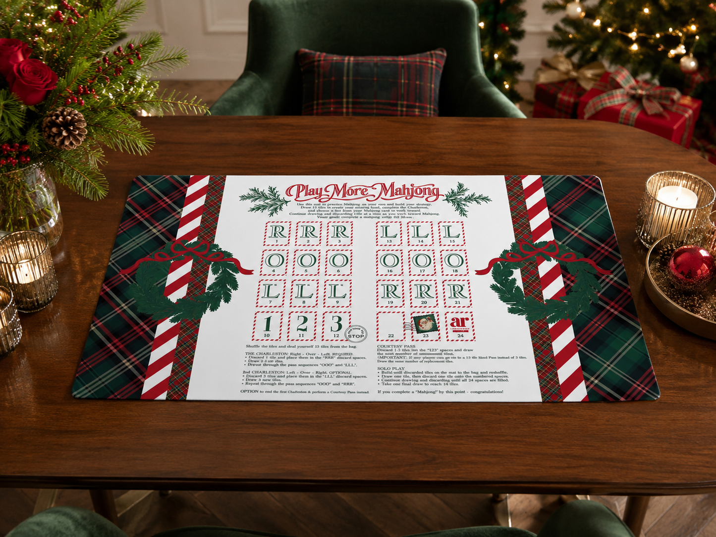 Christmas solo play mahjong mat styled on a holiday table with pine, candles, and wrapped gifts