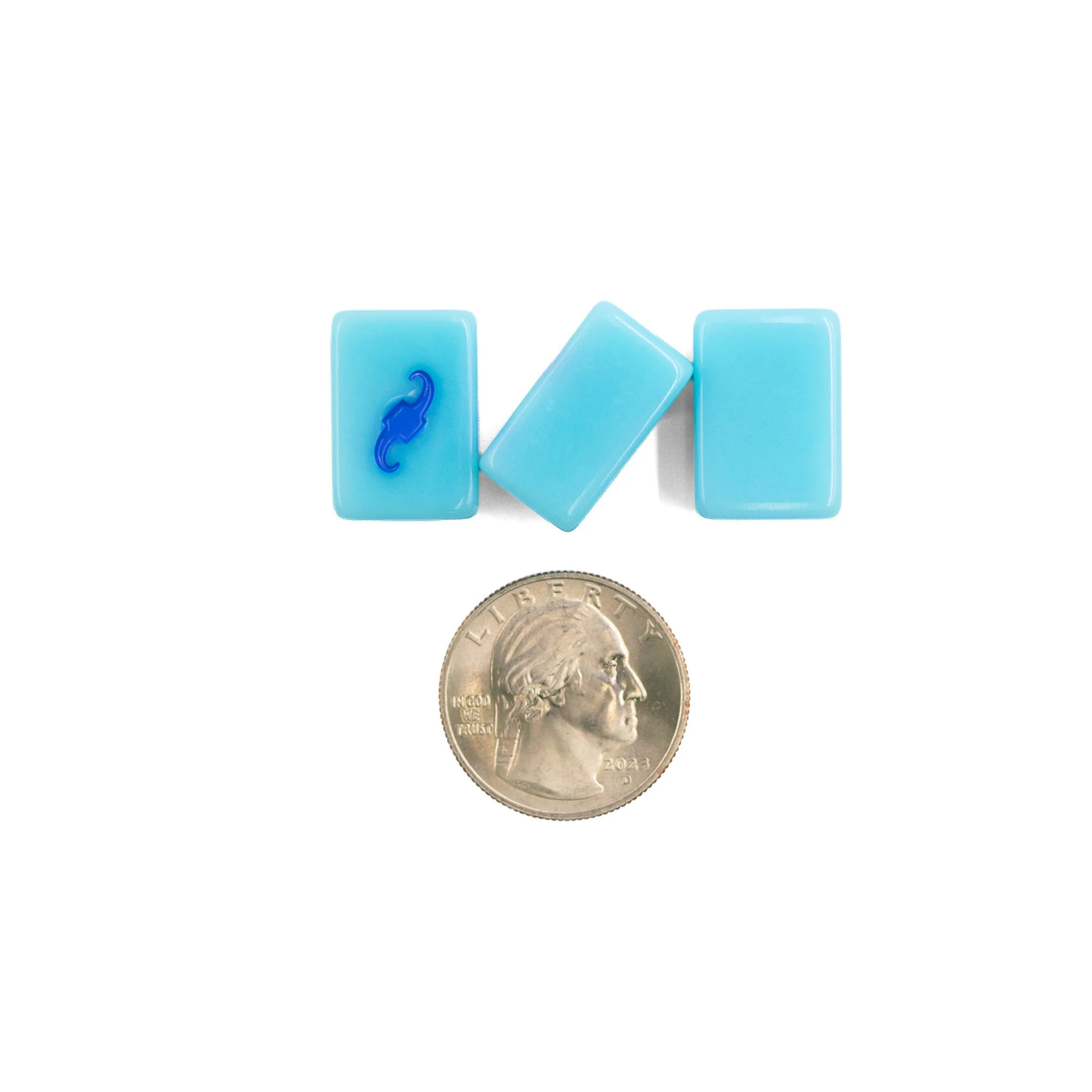 Blue Go Anywhere mini mahjong tiles shown next to a quarter for size scale