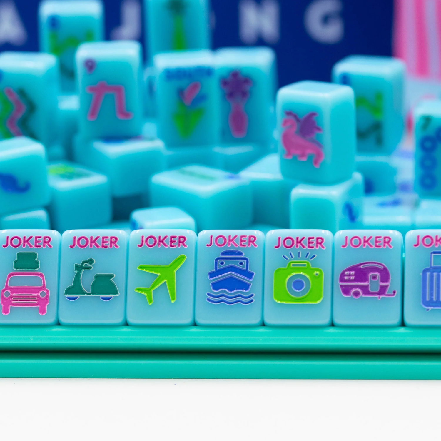 Blue Go Anywhere mini mahjong set: tile pile with travel jokers on a teal mini rack
