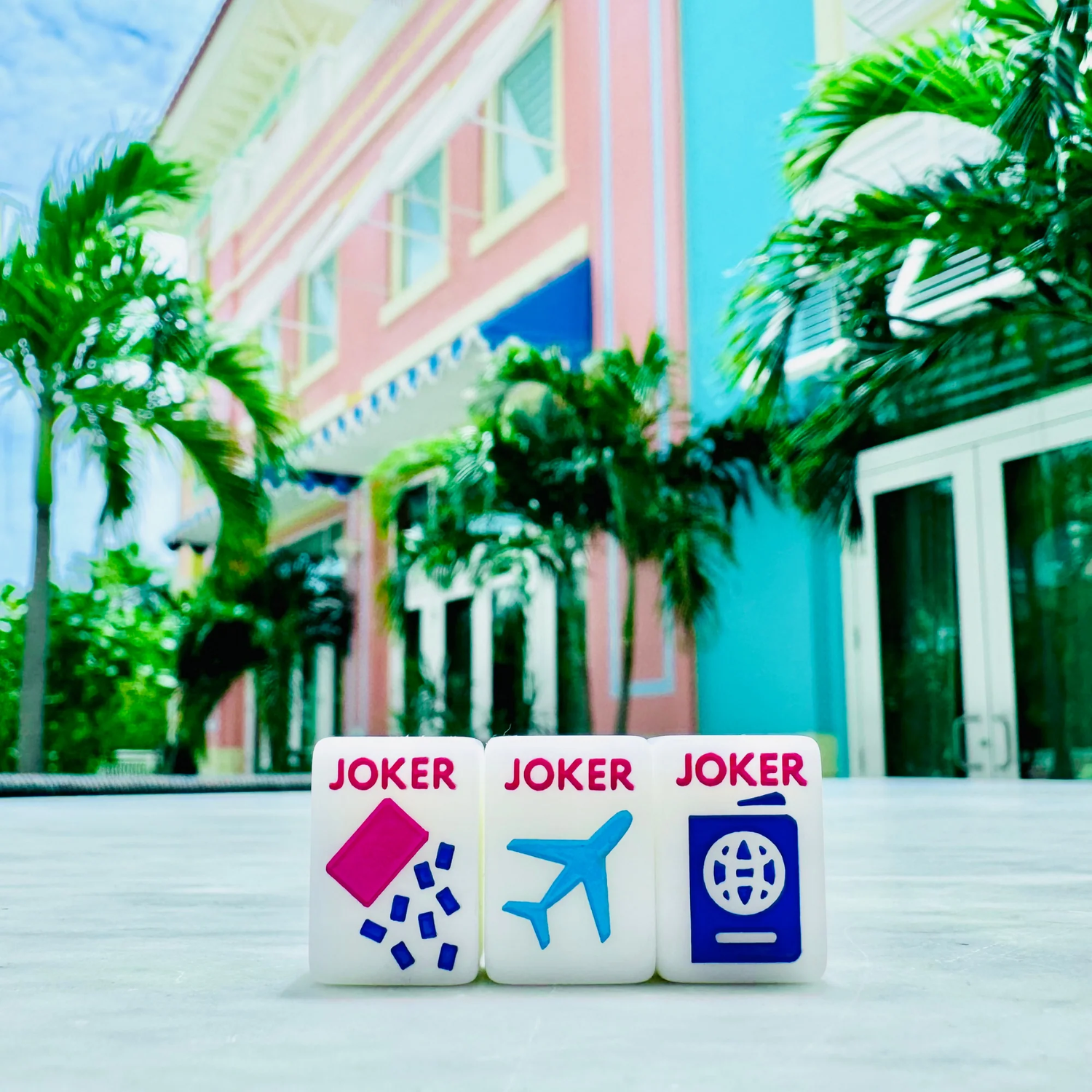 White Go Anywhere mini mahjong joker tiles (dice, plane, passport) at a tropical resort