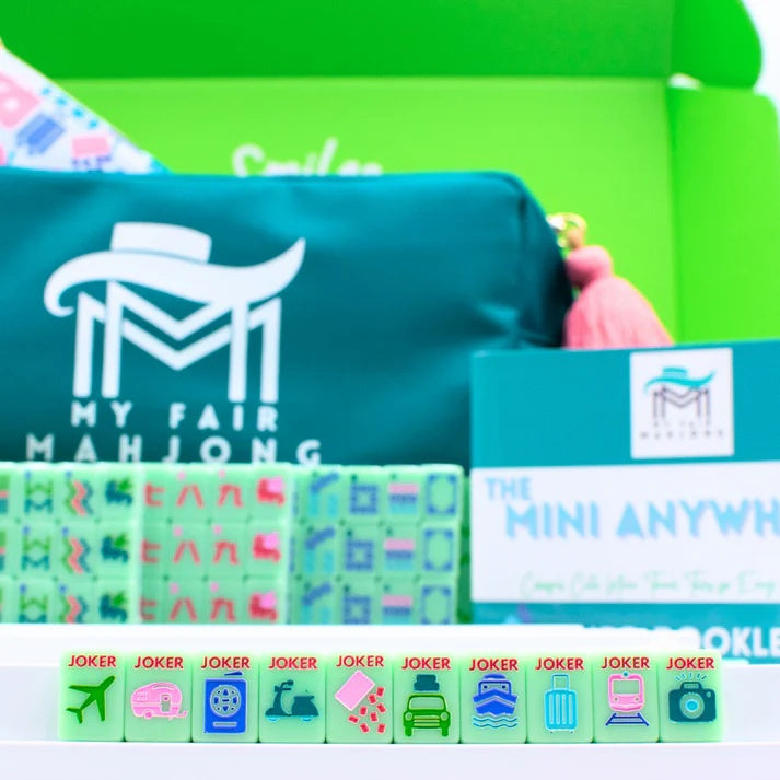 Green Go Anywhere mini mahjong set: teal carry-all bag, travel jokers on rack and Mini Anywhere info card