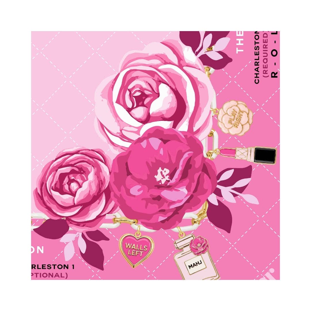 Corner detail of the Charming Blooms mahjong mat with pink peonies and a Charleston directional guide