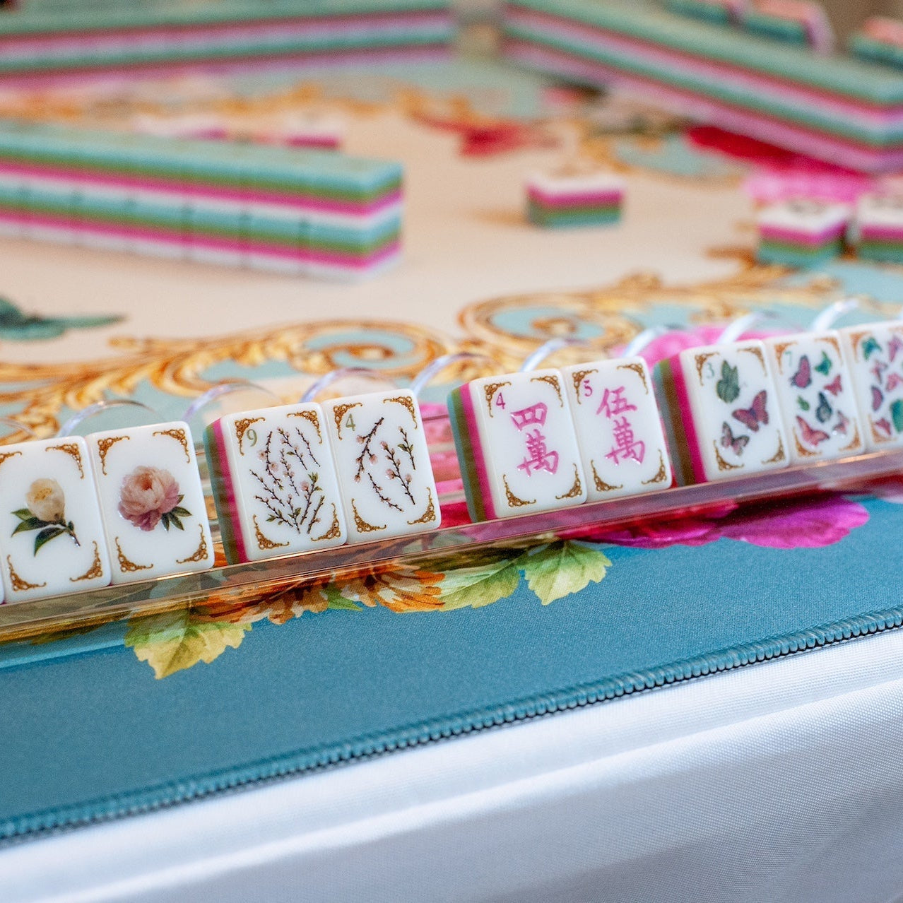 Mahj in Bloom mahjong tiles on a rack — peony flowers, botanical bams, and butterfly dots