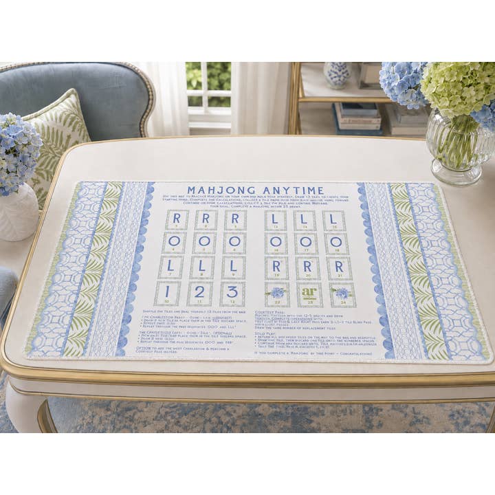 House of Hydrangea solo play mahjong mat styled on a table with blue hydrangeas
