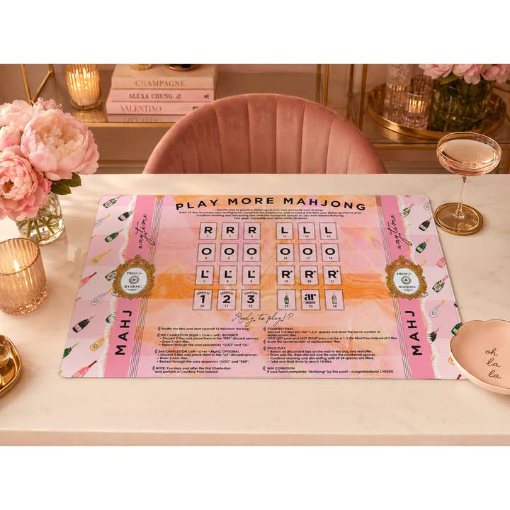 Bams & Bubbly solo play mahjong mat styled on a table — champagne bottle print with solo practice layout