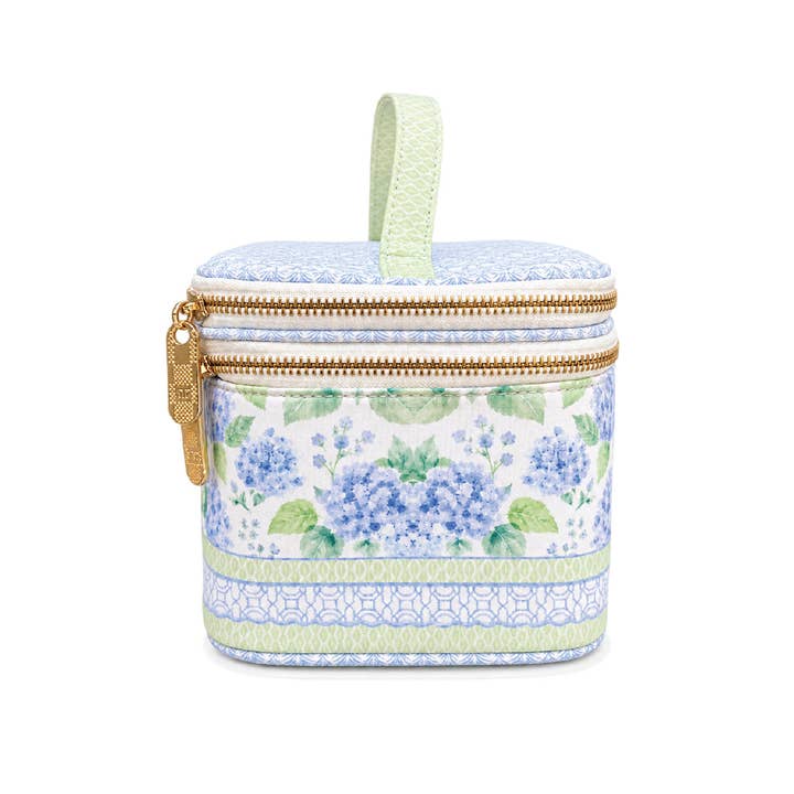 Side view of the House of Hydrangea tile storage case — gold zipper pulls and trellis-print handle